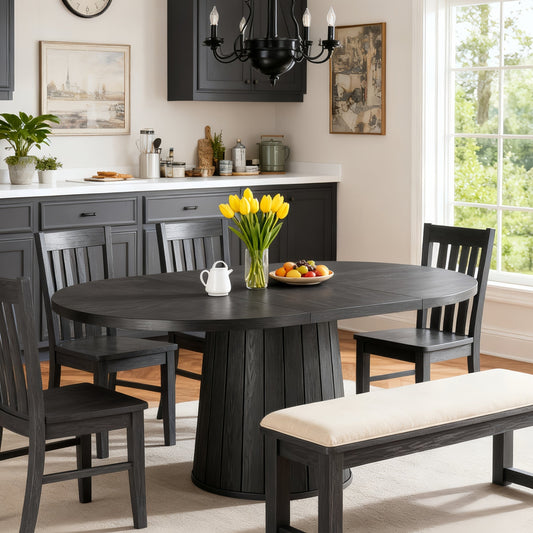 Dining room with a dark wooden table, chairs, and a bench with a vase of yellow tulips.