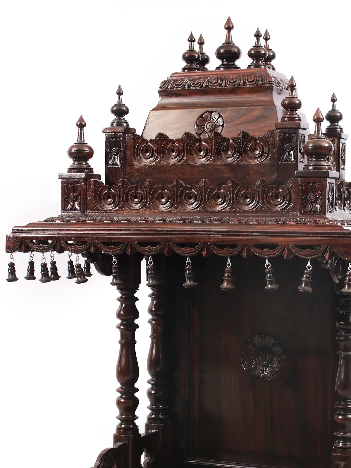 Decorative wooden structure with intricate carvings and embellishments on a white background