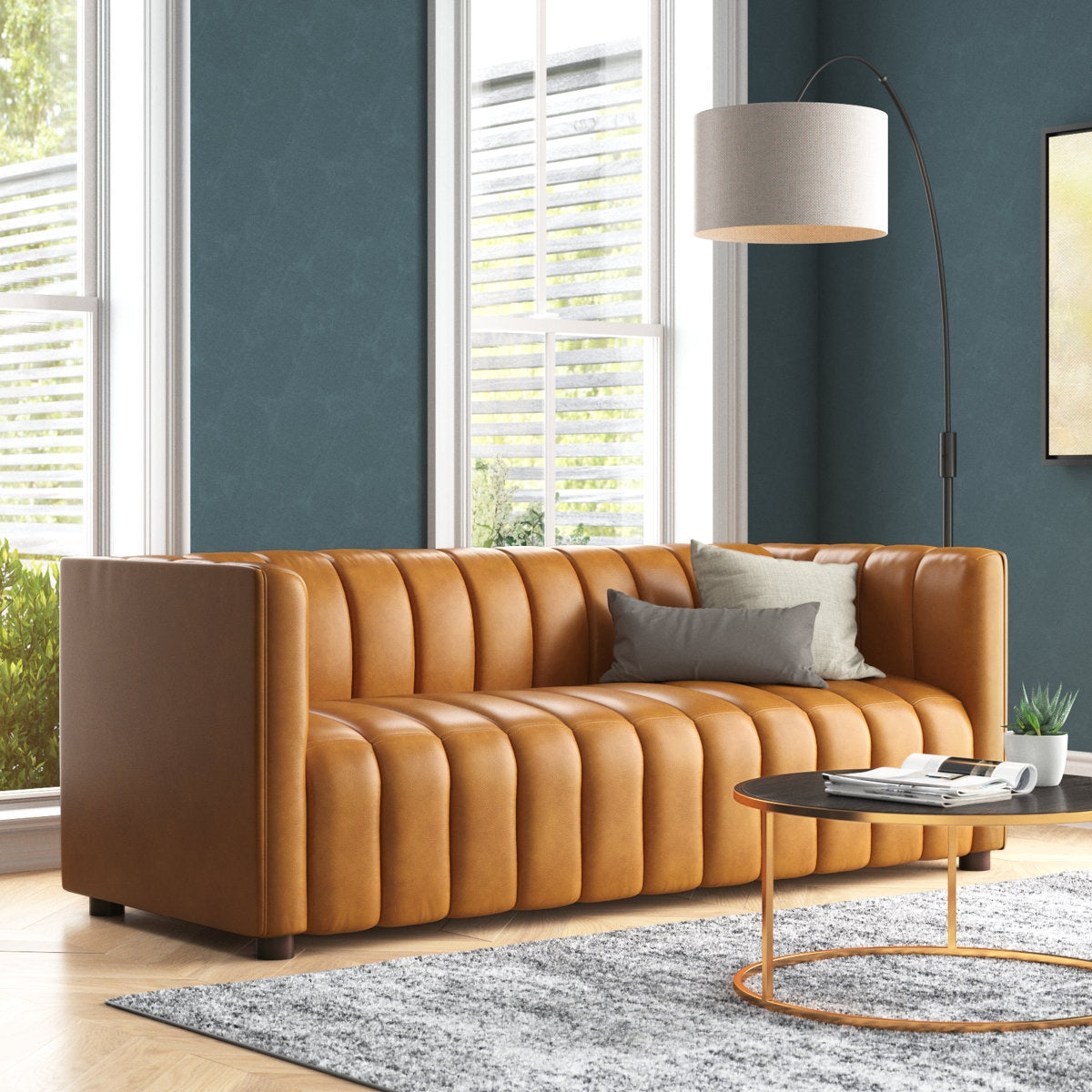 gold leather sofa in a living room with a lamp and small table.