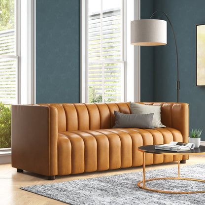 gold leather sofa in a living room with a lamp and small table.