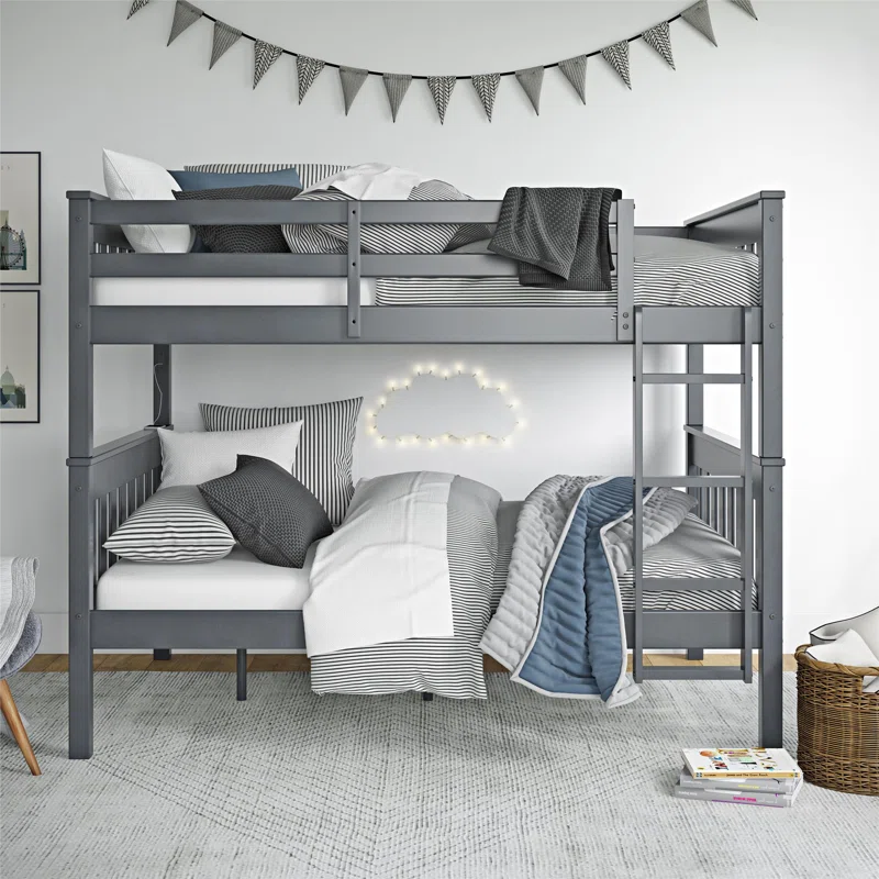 A gray and white bunk bed with lights on in one of the beds, surrounded by pillows and a bookshelf in a cluttered room setup.