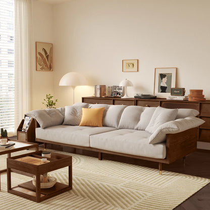 Modern living room with a gray sectional sofa, wooden coffee table, and decorative items.