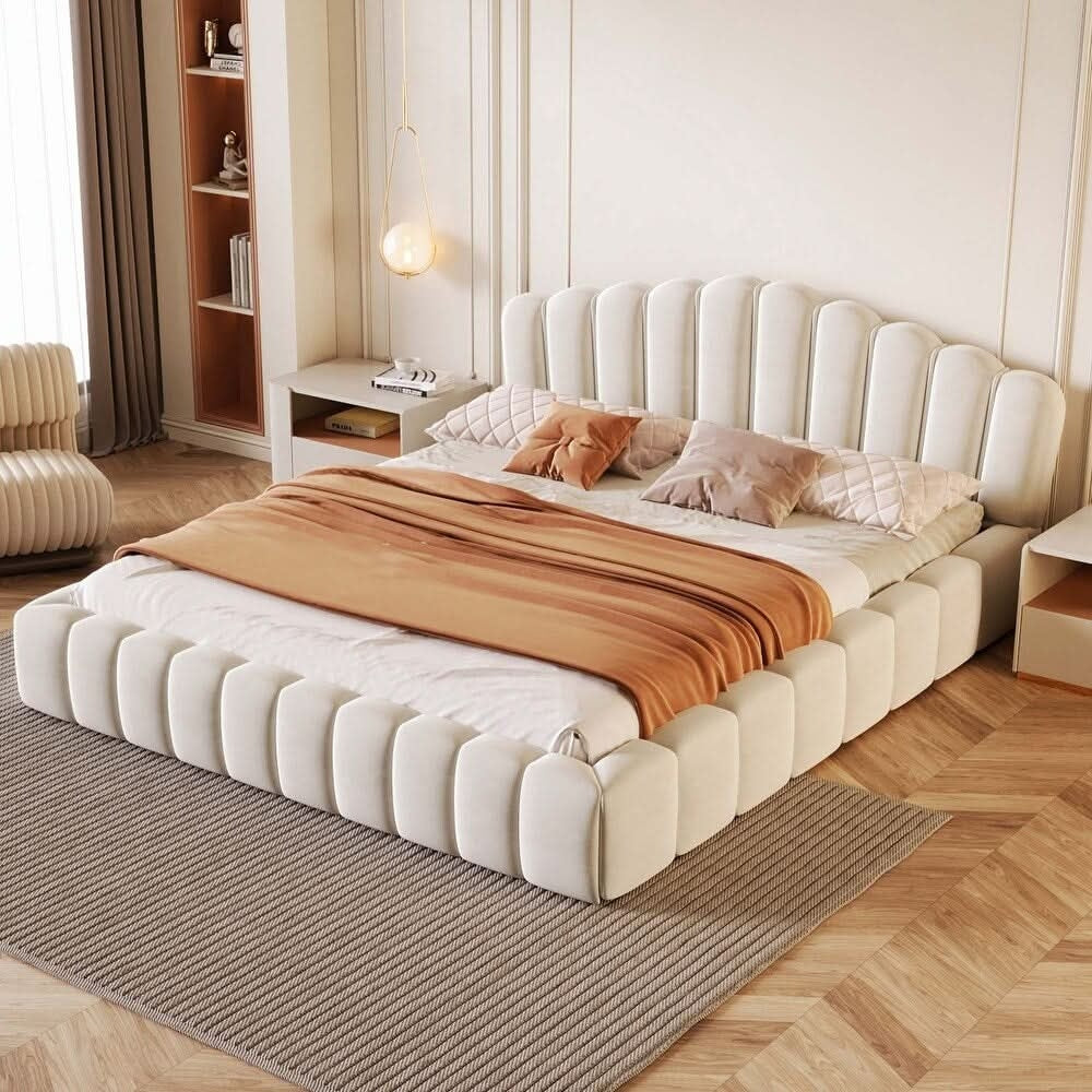 Modern bedroom with a large upholstered bed, brown blanket, and decorative pillows.