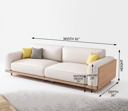 A light beige upholstered sofa with a natural wood frame, shown with dimension arrows and labels indicating width 92 inches, height 28 inches, and depth 36 inches, on a white background.
