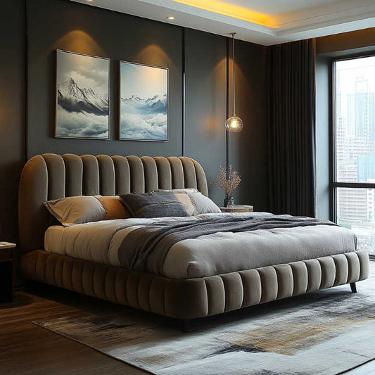 A luxurious velvet upholstered bed with channel tufted headboard and footboard, shown in a bedroom setting with bedding and pillows.