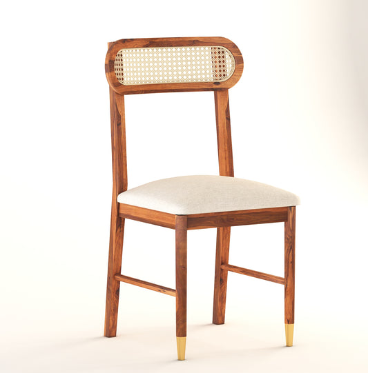 A mid-century modern wooden dining chair with a cane backrest and upholstered seat in a honey and walnut finish.