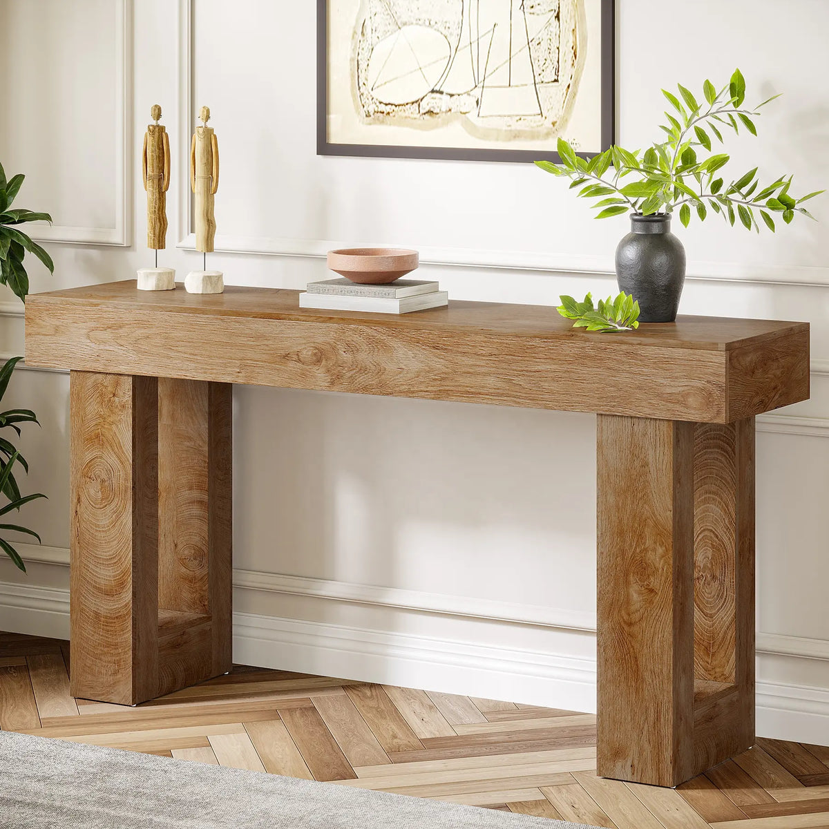 A rectangular Sheesham wood console table placed against a wall with decorative items on top, such as framed pictures, bowls, and vases.