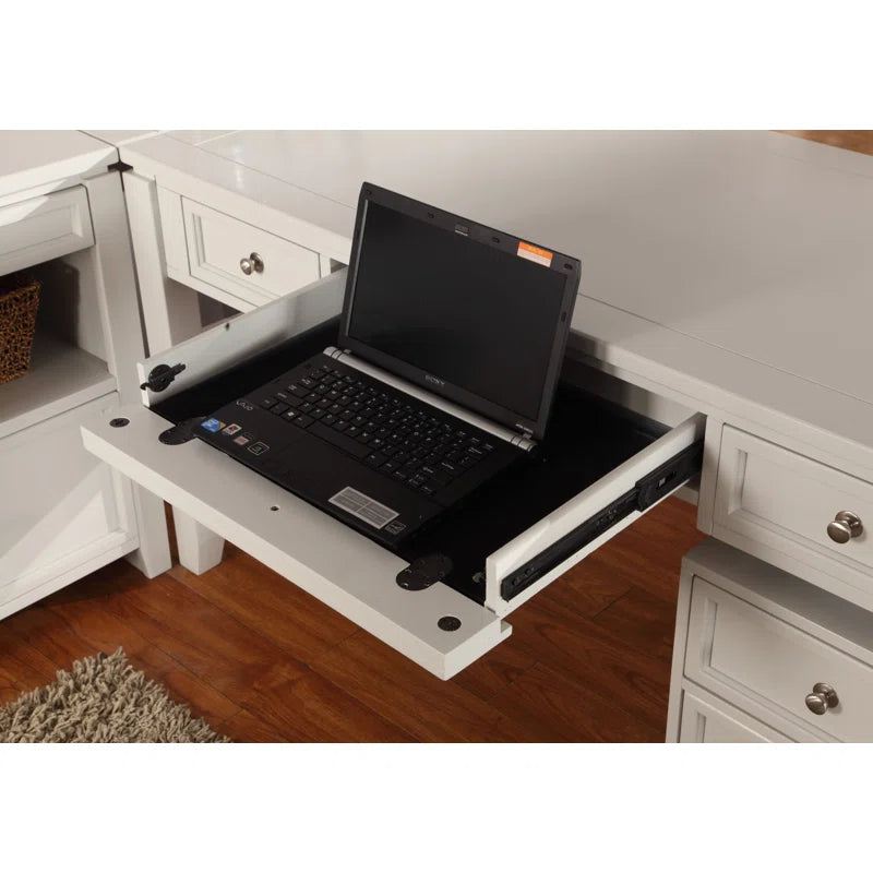 Laptop on a retractable desk extension in a home office.