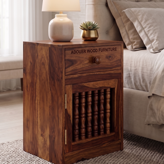 A dark brown wooden nightstand with a single drawer and a carved door, shown in a bedroom setting next to a bed. The nightstand features the text 'ADOUER WOOD FURNITURE' on the front of the drawer.