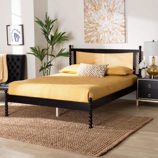 A solid sheesham wood vintage rattan cane bed with a natural finish, placed in a bedroom setting with decorative pillows, a nightstand, and a rugs on the floor.