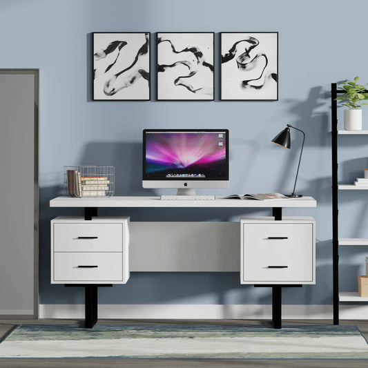 A white finish Sheesham wood study table with metal legs, featuring two drawers on each side and a cabinet, arranged in a home office setting with a computer monitor, lamp, and decorative items.