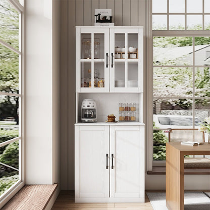 White kitchen cabinet with glass doors in a bright room with large windows.
