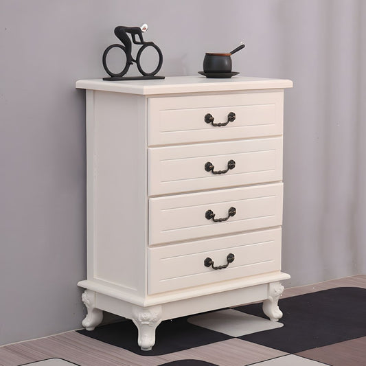 A white wooden four-drawer bedside table with ornate black handles and carved legs, displayed in a room setting.