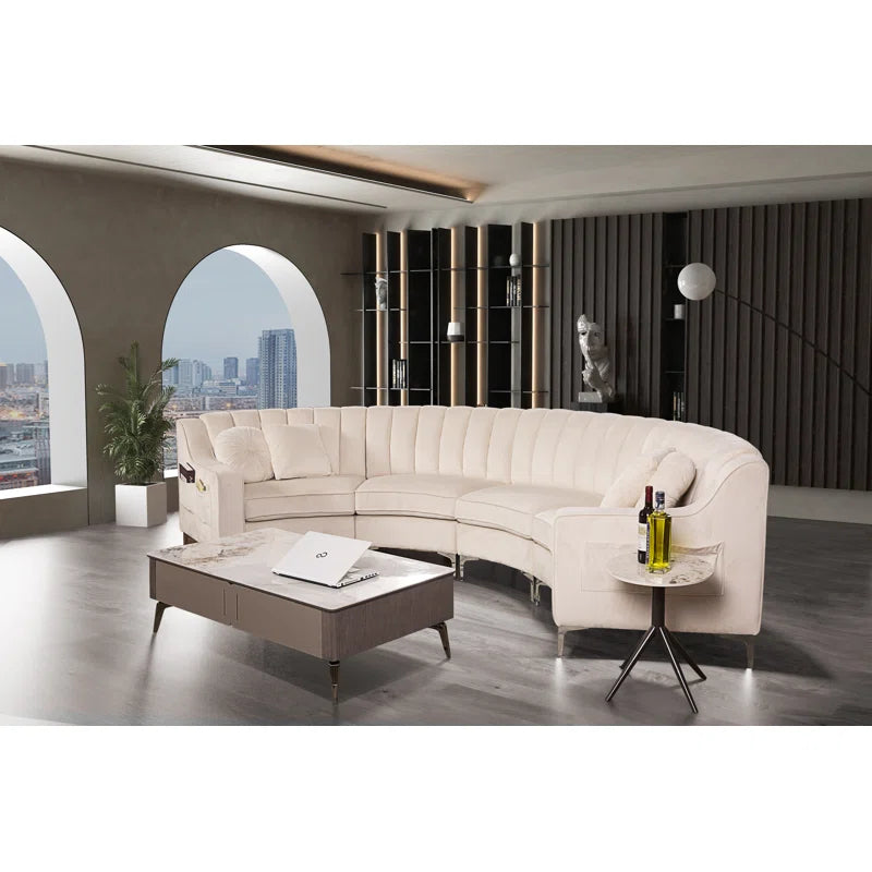 Modern living room with a curved beige sofa, coffee table, and side table.