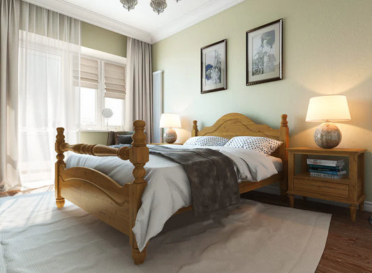 A wooden bed frame with a classic headboard design, placed in a bedroom setting with a mattress on top, accompanied by nightstands with lamps on each side.