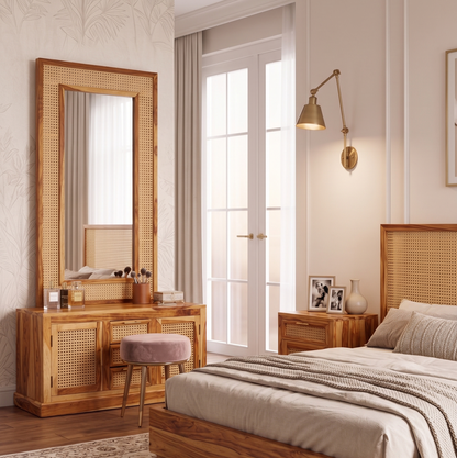 Neatly arranged bedroom with wooden furniture, including a bed, dresser, and mirror.