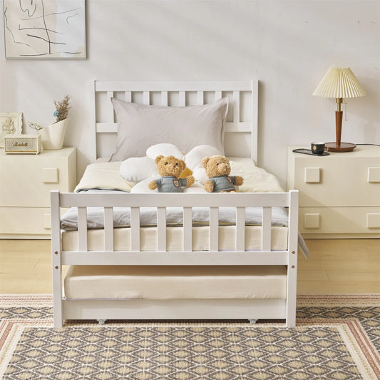 A white, solid sheesham wood trundle bed with a mattress base, positioned in a bedroom setting with two stuffed toy bears on top of the bed.