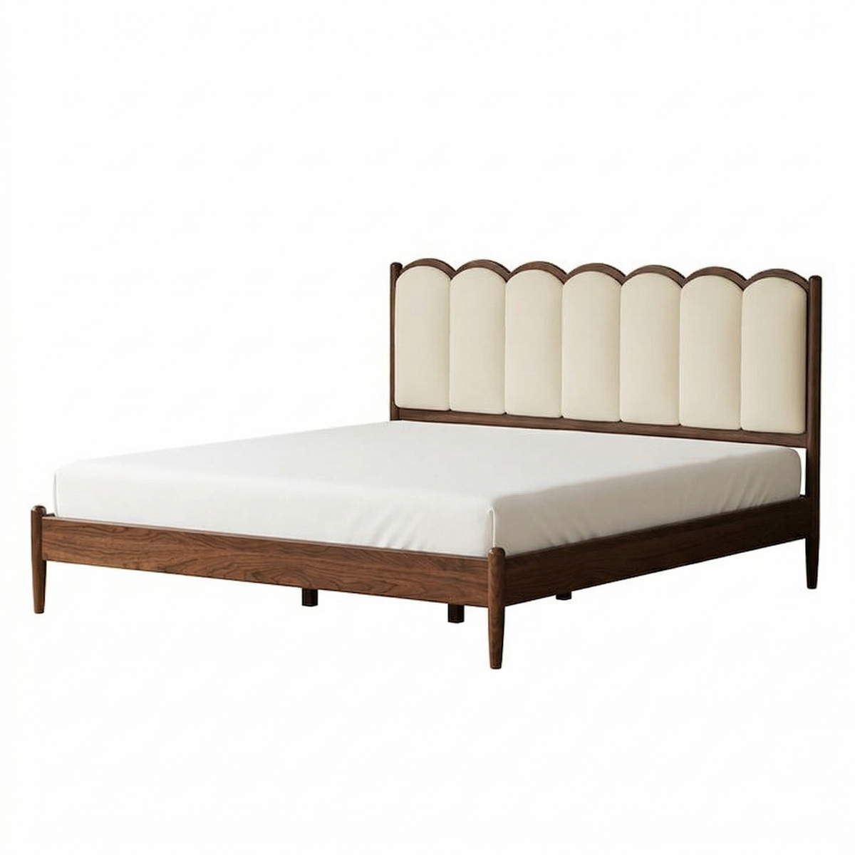 Bed with wooden frame and scalloped headboard on a white background
