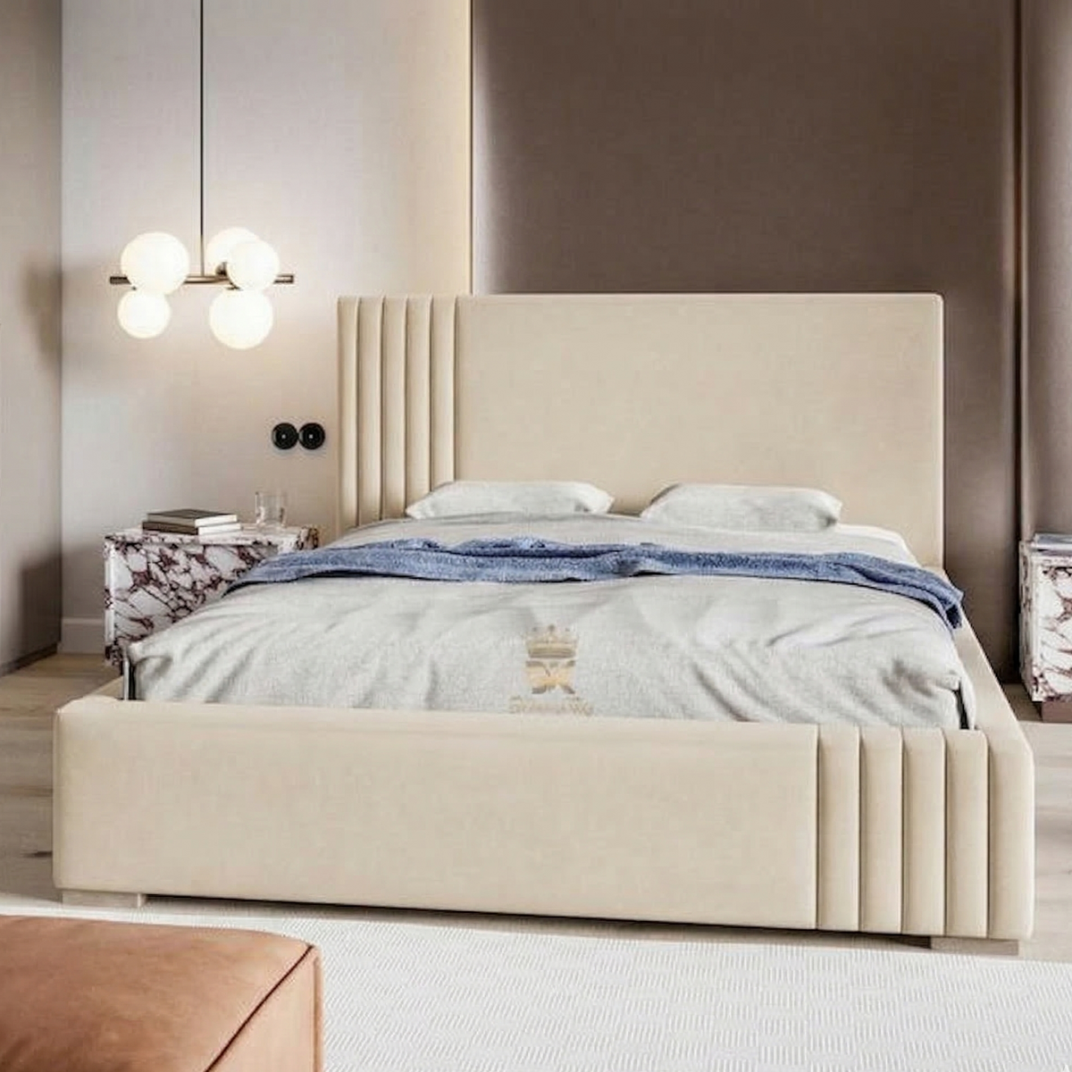 Beige upholstered bed in a modern bedroom setting with neutral walls and decor.