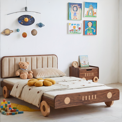 Children's bedroom with a wooden bed shaped like a car, teddy bear, and colorful toys.