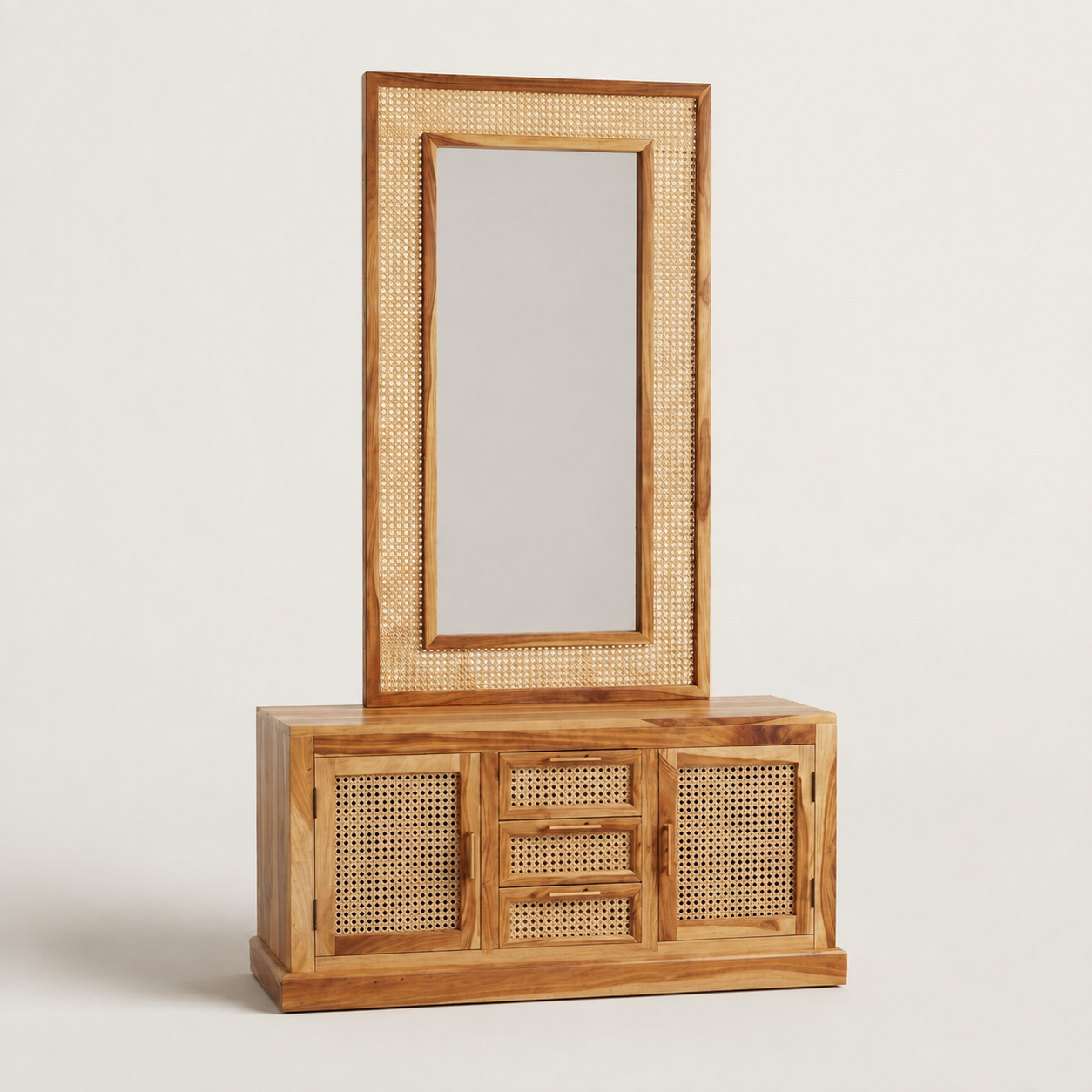 A wooden vanity cabinet with an attached tall mirror, featuring natural cane woven into the frame and door panels, set against a plain light gray background.