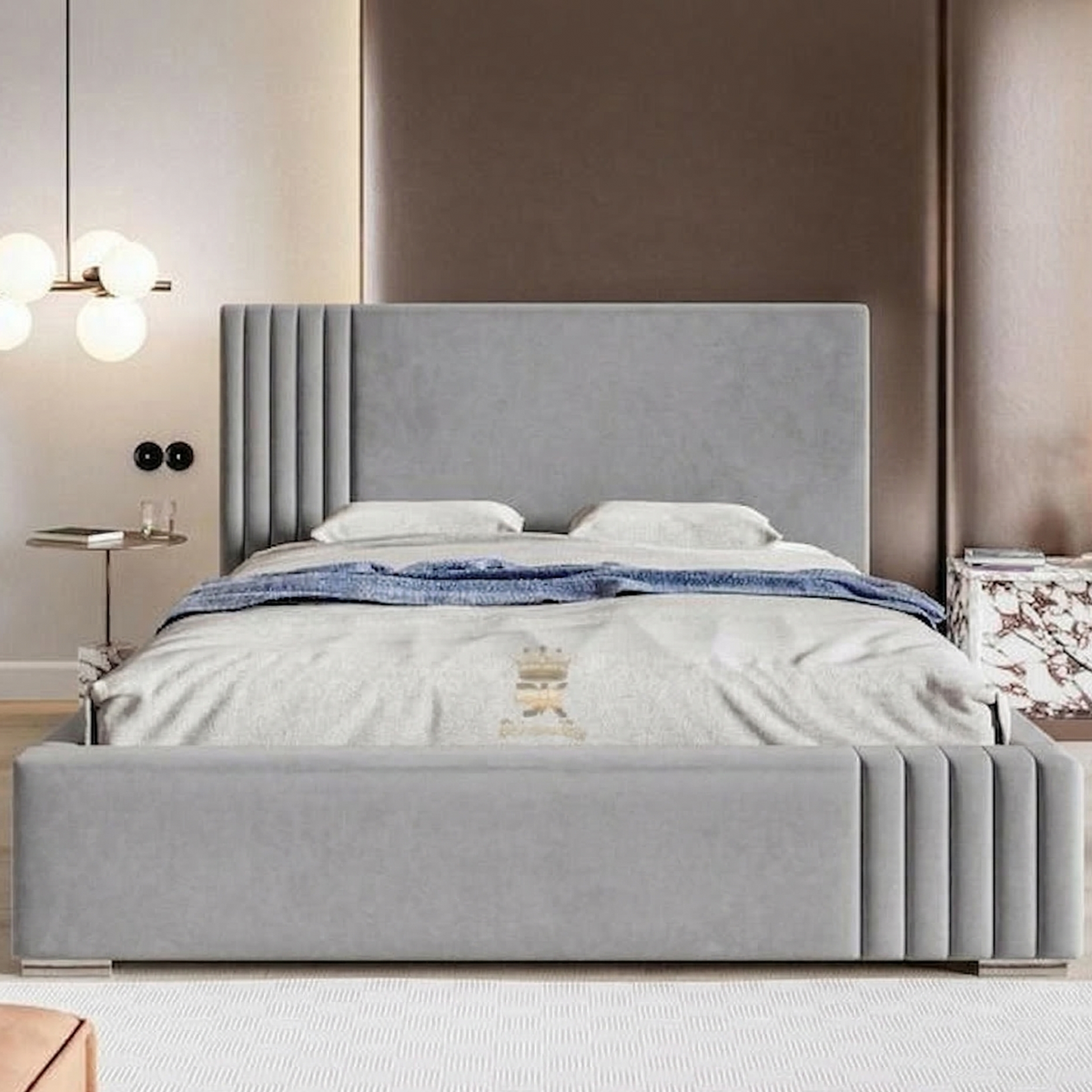 Gray upholstered bed in a bedroom setting with a headboard and bedding.