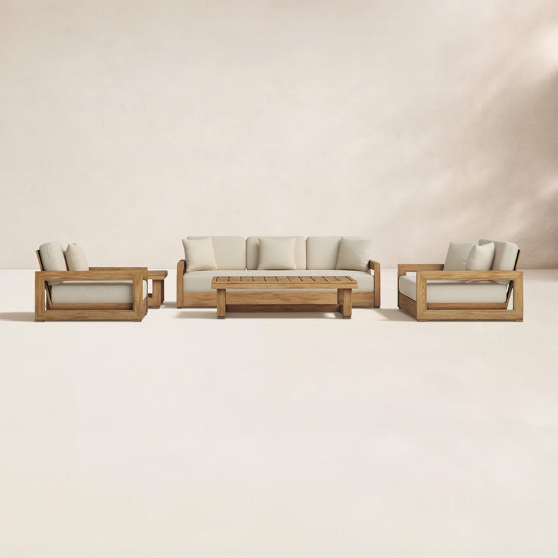 Outdoor furniture set with wooden frames and white cushions on a neutral background