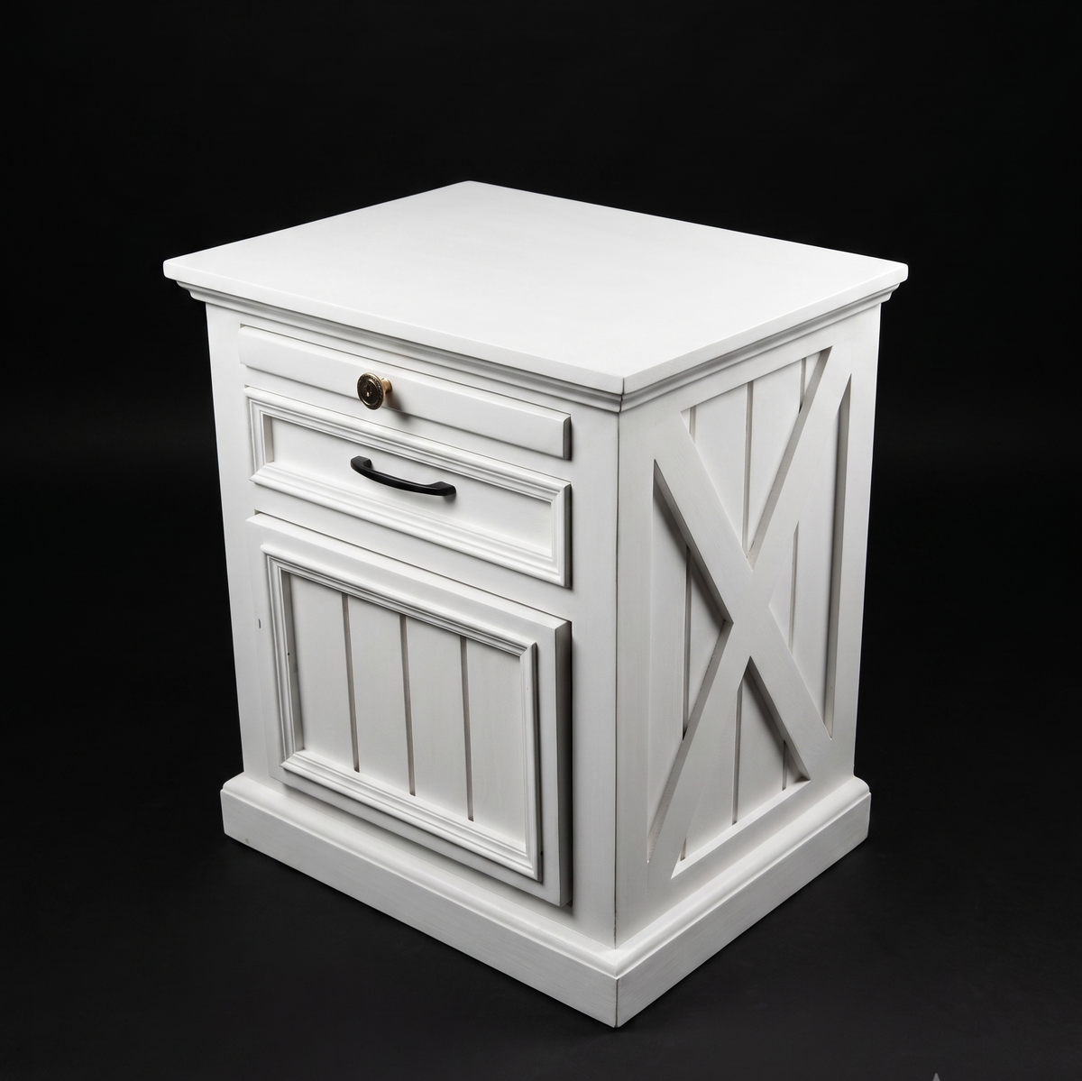 White wooden side table with a drawer and decorative cross design on a black background