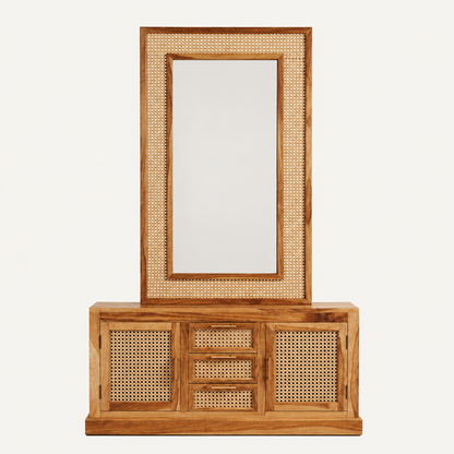 A wooden entryway console table with a tall matching mirror, featuring natural cane rattan woven panels on the doors, drawers, and mirror frame, set against a plain off-white background.
