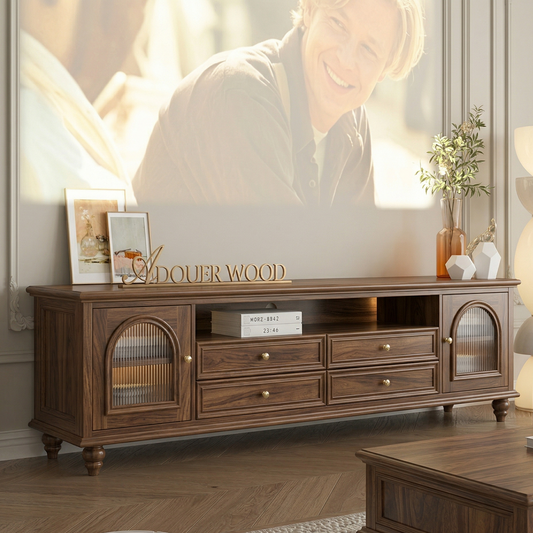 Wooden TV stand with decorative items in a living room setting.
