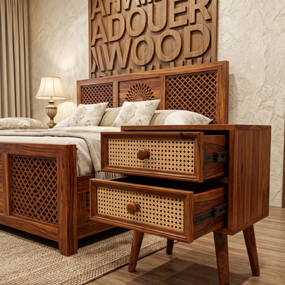 Wooden bed with intricate design and open drawer in a bedroom setting.