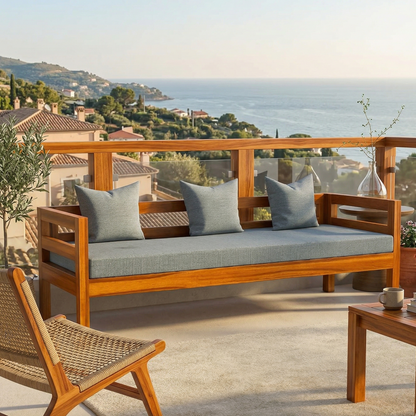 Wooden outdoor sofa with gray cushions on a balcony with ocean view