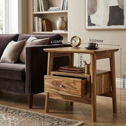 Wooden side table with a brown sofa and decorative items in a living room setting.
