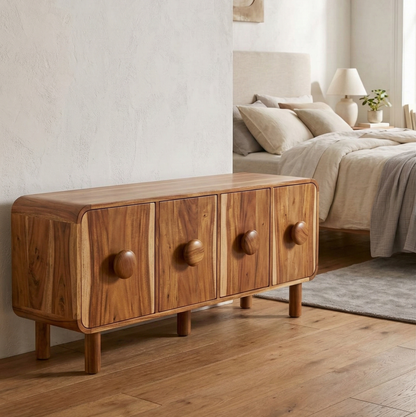 Wooden storage with four drawers in a bedroom setting