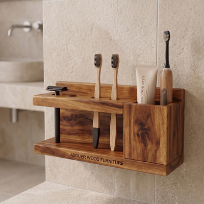Wooden toothbrush holder with toothbrushes and toothpaste on a bathroom wall.
