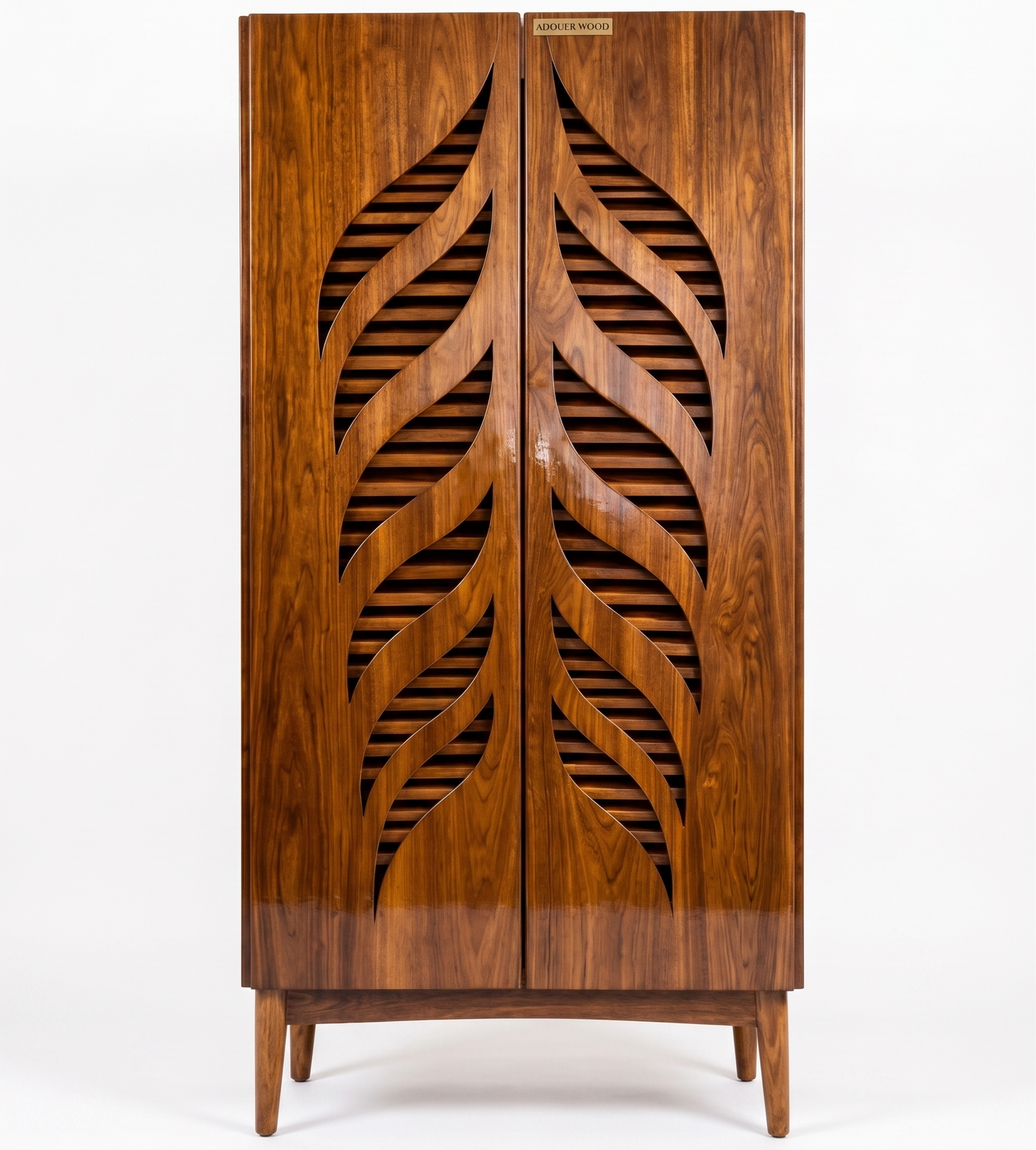 A mid-century modern wooden cabinet featuring two doors with a large leaf-shaped cutout design over a slatted wood backing, finished in a warm reddish-brown tone with a small gold-toned brand plaque at the top.