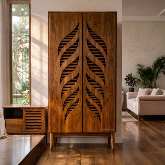 A tall wooden cabinet with two doors featuring large leaf-shaped cutout patterns, shown in a modern living room setting.