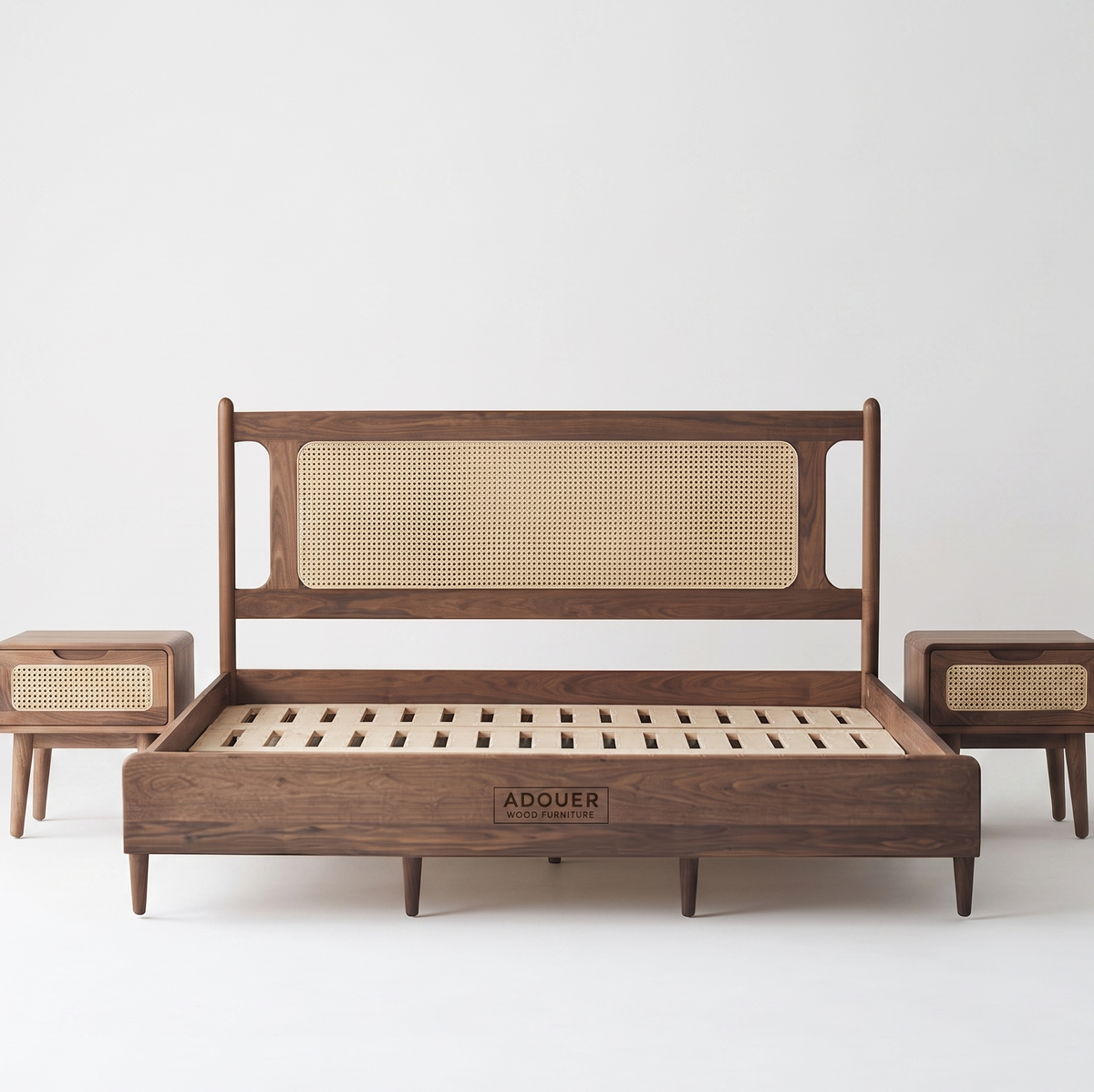 A mid-century modern wooden bed frame with a cane panel headboard, shown with two matching wooden nightstands on a light gray background. The brand name 'ADOUER' is visible on the front of the footboard.