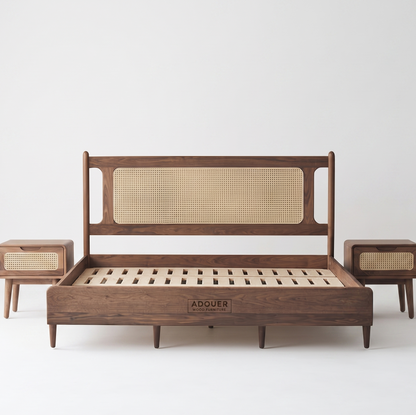 A mid-century modern wooden bed frame with a cane panel headboard, shown with two matching wooden nightstands on a light gray background. The brand name 'ADOUER' is visible on the front of the footboard.