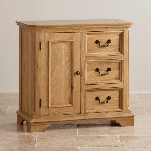 Wooden cabinet with a door and three drawers on a tiled floor.