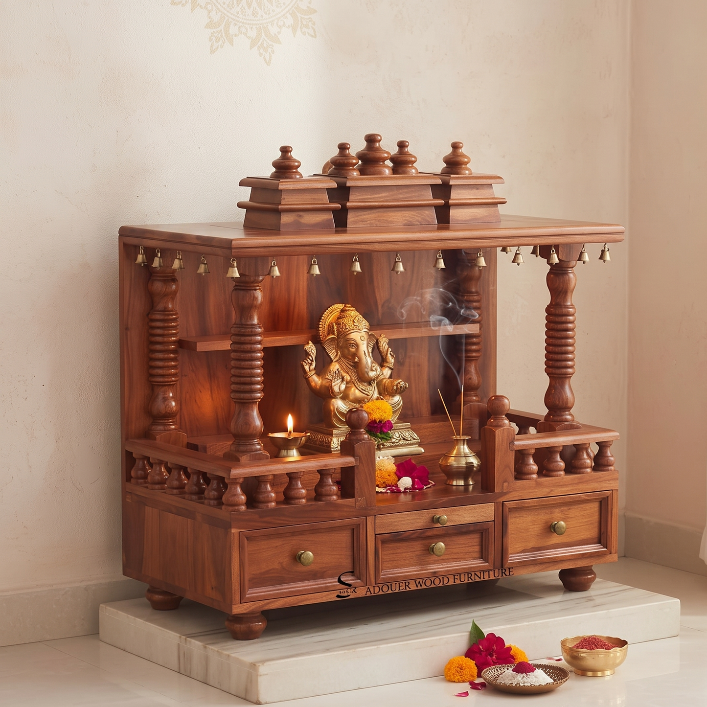 A dark reddish-brown wooden Ganesh idol stand with carved pillars, drawers, and brass bells, placed on a white marble platform in a clean indoor setting.