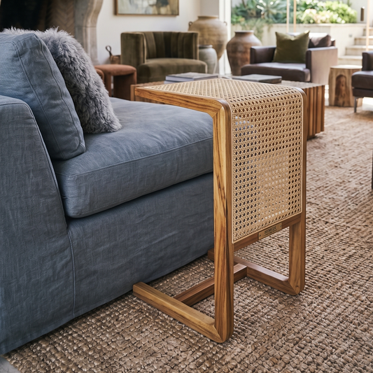 Gray sofa with a wicker side table in a living room setting