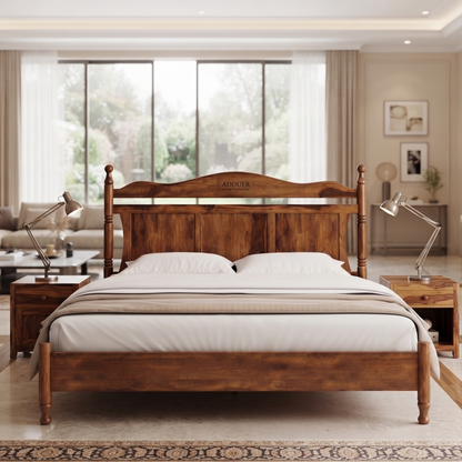 A wooden bed frame with a carved headboard and matching footboard, dressed in white bedding, positioned in a modern, well-lit bedroom with nightstands and lamps.