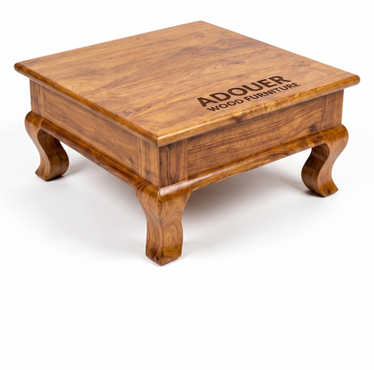 A square wooden coffee table with a rich warm brown finish and carved legs, featuring the brand name 'ADOUER WOOD FURNITURE' engraved on the top surface, set against a plain white background.